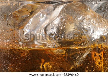 Close up of a Whiskey Glass with ice cubes and water droplets horizontal composition