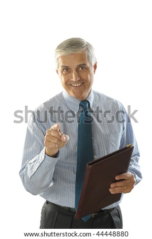 Middle Aged Businessman holding a leather folder smiling and pointing at camera vertical format torso only