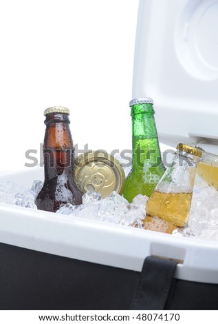 Close up of an assortment of beer bottles and cans in cooler with ice vertical composition