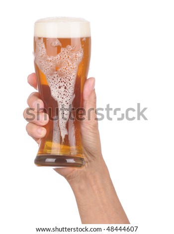 Man\'s Hand Holding up a Glass of Foamy Beer with froth dripping down the side over a white background