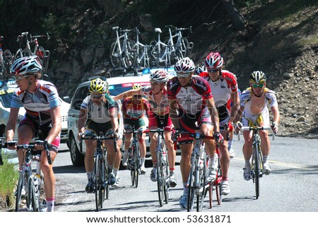 RUNNING SPRINGS, CA - MAY 21: Cyclists, followed by team cars, tackle  Stage 6 of the Amgen Tour of California on May 21, 2010. The Tour of California is the largest cycling event in America.