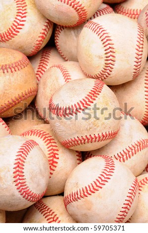 Closeup of a pile of old used baseballs in vertical format.