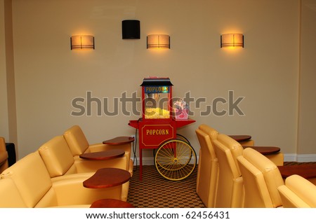 Private home theater with plush seats and popcorn machine