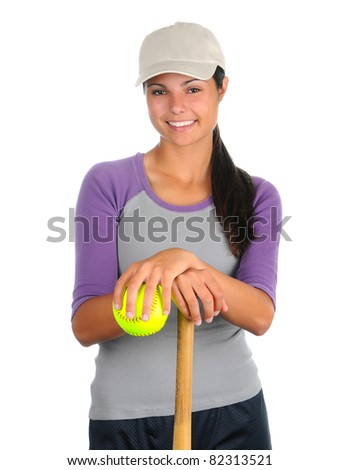 Closeup of a smiling female softball player leaning on a wooden bat and holding a ball. Vertical format isolated on white.