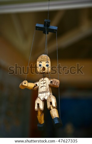 Wooden Pinocchio puppet with strings attached