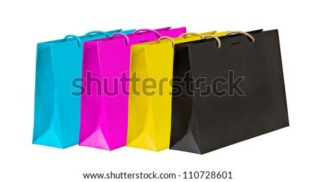 Cyan, magenta, yellow and black shopping bags on white.