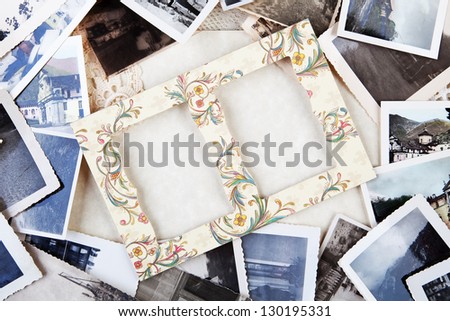 A pile of old photographs with space for your logo or text.