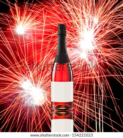 Fireworks against a black sky and wine bottle