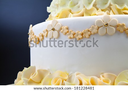 Detail of wedding cake with yellow flowers