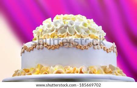 Wedding cake with white and yellow flower on red