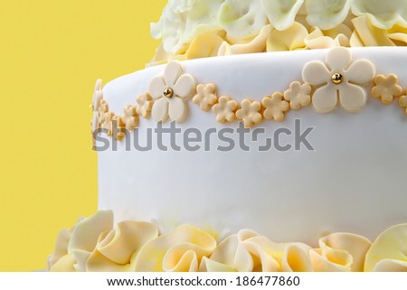 Wedding cake with white and yellow flower on yellow