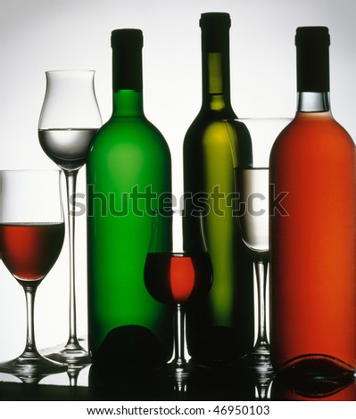 Three wine bottles and four glasses. White, red and rose wine.
