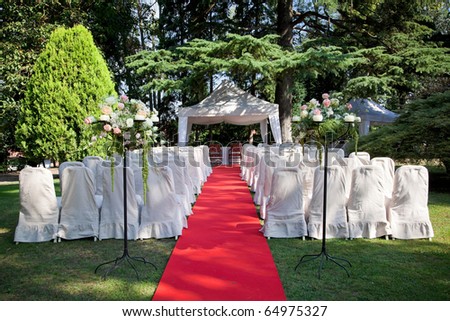 stock photo Red carpet and chairs for an outdoor wedding