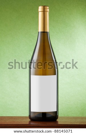 White wine bottle on green background with blank label