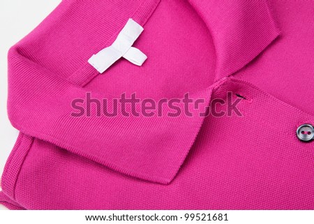Detail of a pink polo shirt.