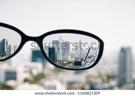 Close up of spectacles on blurry city background. Clean vision concept.