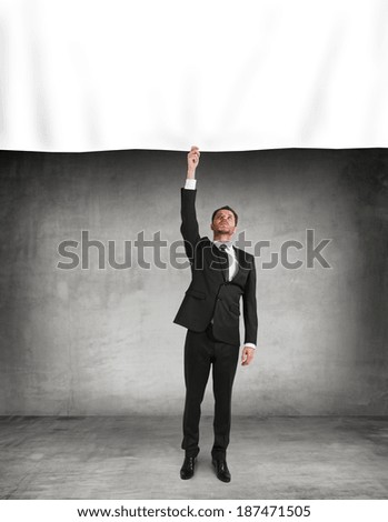 businessman puts a poster standing in old room