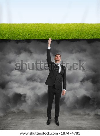 businessman puts a poster with field