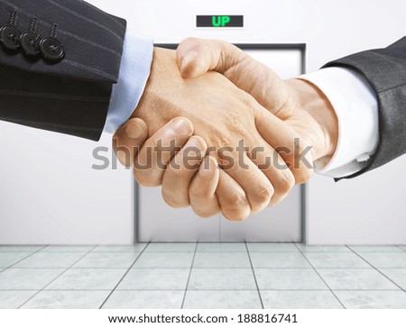 business handshake on a elevator background