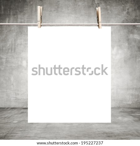 white paper hanging on clothespins