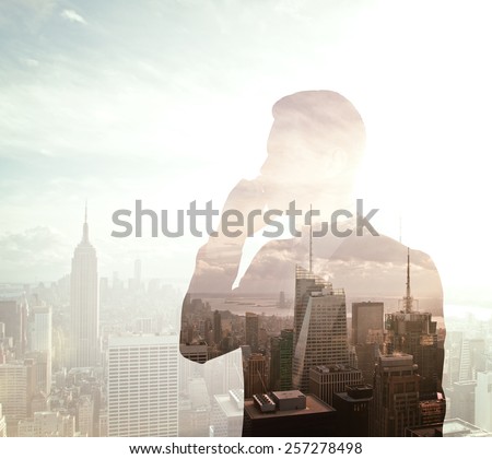businessman with phone on city background, double exposure