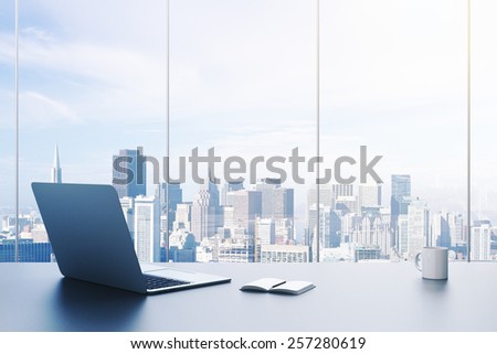pc, cup and diary on table in office