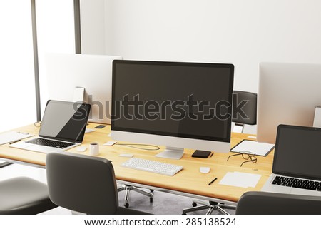 Wooden conference table with office accessories and computers