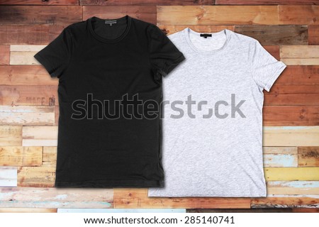 Blank t-shirts on a wooden surface