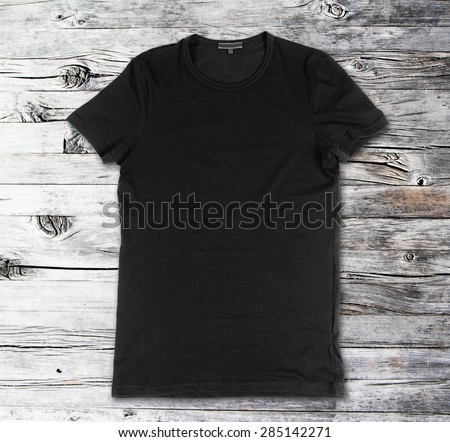 Blank black t-shirt on a wooden surface