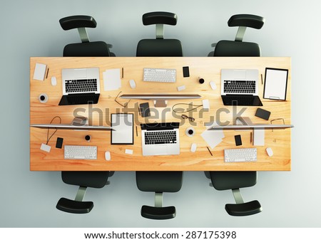 top view of conference table with office accessories and computers