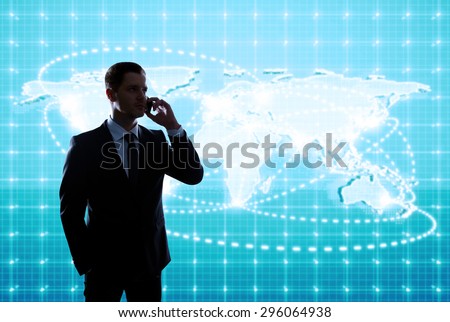 businessman standing in office with global business map