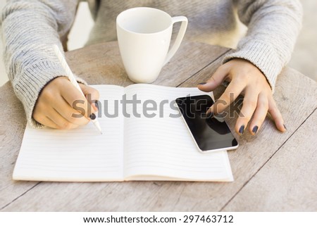 girl with cell phone and diary