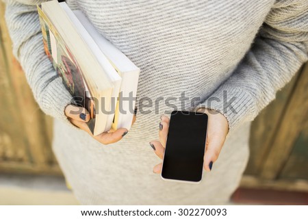 girl with blank cell phone and books