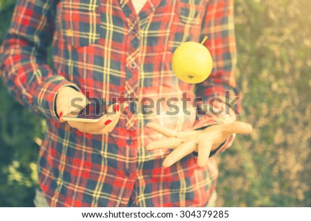 Girl with cell phone and green apple