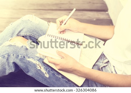Girl making notes in the diary