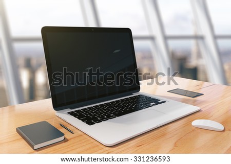 Blank screen of laptop with diary and cell phone on a wooden table in sunny room, mock up