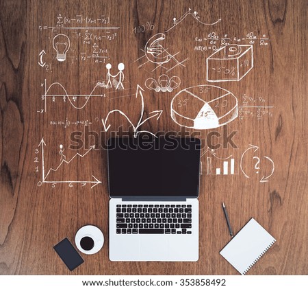 Blank black laptop screen with smartphone on wooden floor with business scheme concept, mock up