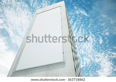 Blank white billboard on the wall of high building with blue sky, mock up