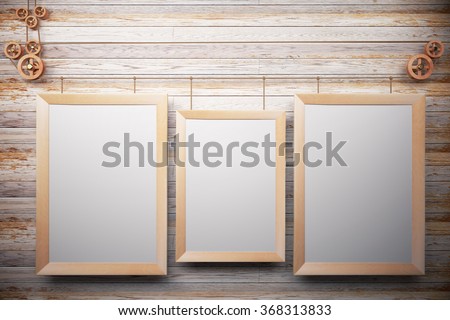 Blank wooden picture frames on wooden wall, mock up