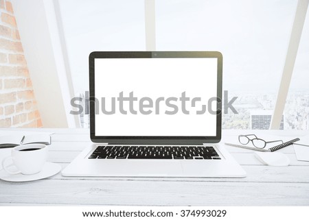 Blank white laptop screen on white wooden table with eyeglasses and cup of coffee at sunrise, mock up