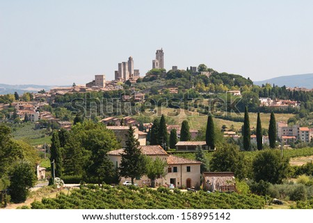 TUSCANY, AUGUST 16, Landscape with houses, hills and San Gimignano in the distance, on Tuscany 16, 2013