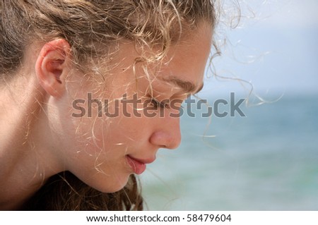 Face of the beautiful young woman in profile