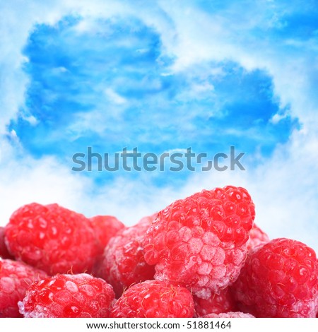 Delicious icy raspberries against a beautiful blue background with a lot of copy space.