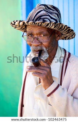 Old man smoking his pipe