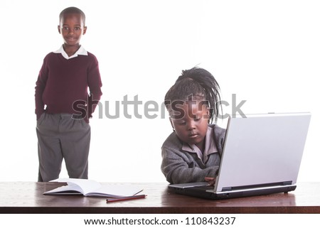 The little girl is trying to figure out how the computer works.