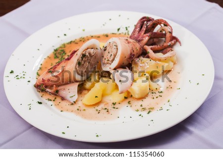 A plate of squid stuffed with chicken and potatoes.