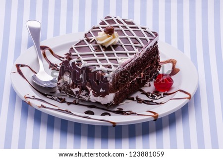 A small plate with chocolate cake consisting out of two layers.
