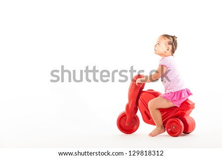 A toddler with her three wheel bike, very concerned about the condition.