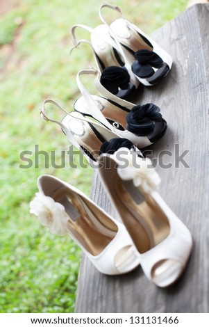 The beautiful shoes of the bride with flowers on the side.