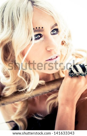 beautiful caucasian model with blond curly hair wearing drastic silver and black make-up